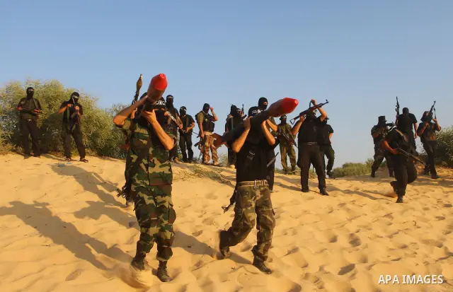 Palestinian militants from the Popular Resistance Movement participate in a training session in the southern Gaza Strip town of Khan Younis on Sept.30,2011. Israel on Tuesday approved construction of 1,100 homes for Jews...