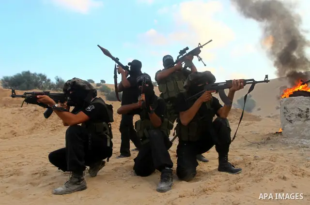 Palestinian militants from the Popular Resistance Movement participate in a training session in the southern Gaza Strip town of Khan Younis on Sept.30,2011. Israel on Tuesday approved construction of 1,100 homes for Jews...