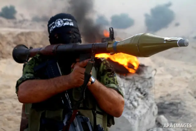 Palestinian militants from the Popular Resistance Movement participate in a training session in the southern Gaza Strip town of Khan Younis on Sept.30,2011. Israel on Tuesday approved construction of 1,100 homes for Jews...