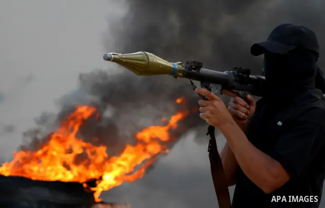 Palestinian militants from the Popular Resistance Movement participate in a training session in the southern Gaza Strip town of Khan Younis on Sept.30,2011. Israel on Tuesday approved construction of 1,100 homes for Jews...