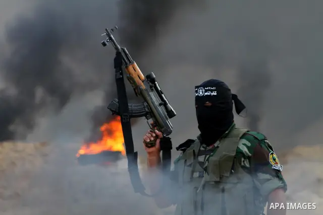 Palestinian militants from the Popular Resistance Movement participate in a training session in the southern Gaza Strip town of Khan Younis on Sept.30,2011. Israel on Tuesday approved construction of 1,100 homes for Jews...