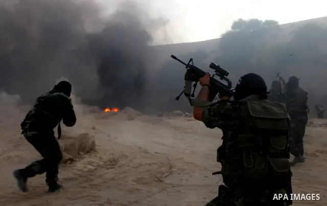 Palestinian militants from the Popular Resistance Movement participate in a training session in the southern Gaza Strip town of Khan Younis on Sept.30,2011. Israel on Tuesday approved construction of 1,100 homes for Jews...