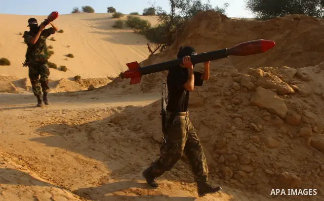 Palestinian militants from the Popular Resistance Movement participate in a training session in the southern Gaza Strip town of Khan Younis on Sept.30,2011. Israel on Tuesday approved construction of 1,100 homes for Jews...