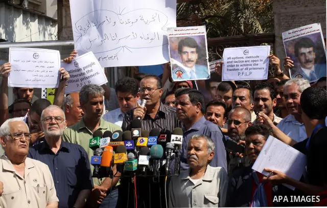Families of Palestinian prisoners held in Israeli jails deliver speech during a protest outside the International Committee of the Red Cross (ICRC) offices in Gaza City on October 3, 2011 in support of prisoners on hunge...