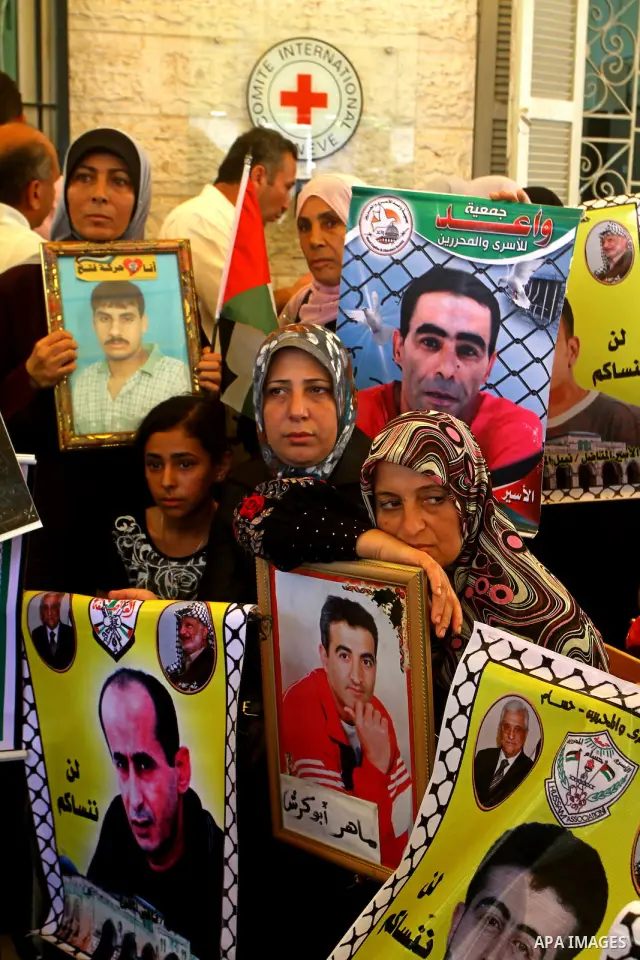 Palestinians take part in a protest at the Red Cross headquarters in Gaza City on October 3, 2011, to show their solidarity with Palestinian prisoners held in Israeli jails. On Wednesday, Palestinian prisoners in Israel...