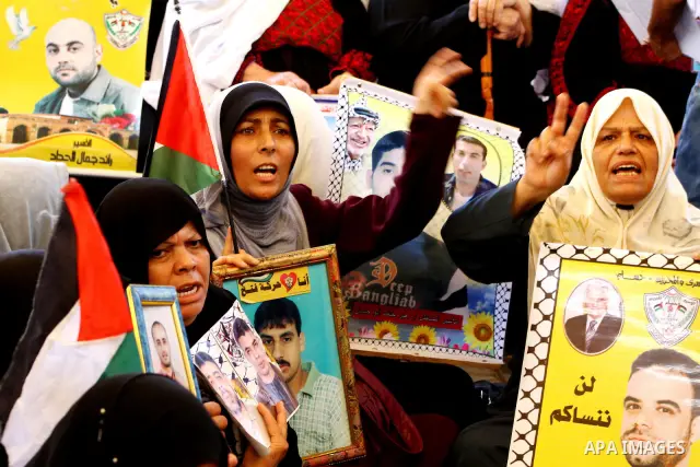 Palestinians take part in a protest at the Red Cross headquarters in Gaza City on October 3, 2011, to show their solidarity with Palestinian prisoners held in Israeli jails. On Wednesday, Palestinian prisoners in Israel...