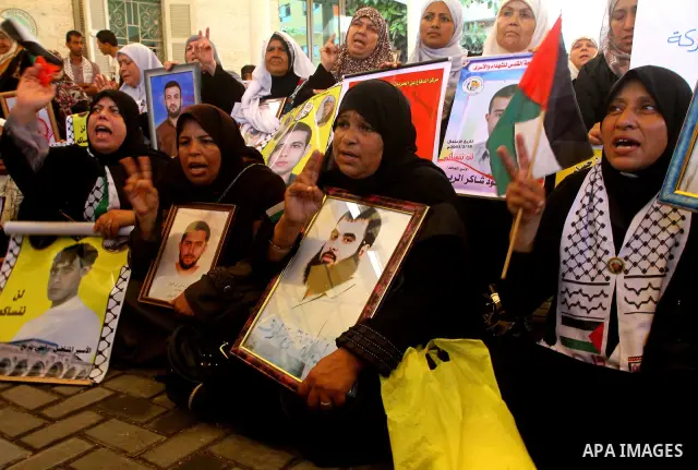 Palestinians take part in a protest at the Red Cross headquarters in Gaza City on October 3, 2011, to show their solidarity with Palestinian prisoners held in Israeli jails. On Wednesday, Palestinian prisoners in Israel...