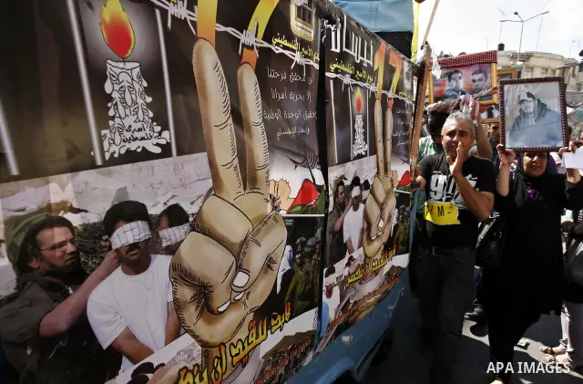 Palestinians take part in a protest in the West Bank city of Nablus on October 3, 2011, to show their solidarity with Palestinian prisoners held in Israeli jails. On Wednesday, Palestinian prisoners in Israel went on a h...