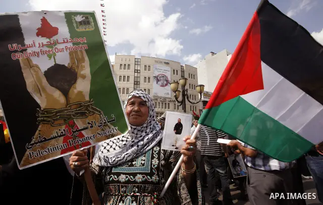 Palestinians take part in a protest in the West Bank city of Nablus on October 3, 2011, to show their solidarity with Palestinian prisoners held in Israeli jails. On Wednesday, Palestinian prisoners in Israel went on a h...