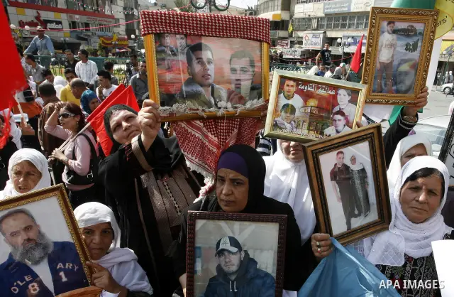 Palestinians take part in a protest in the West Bank city of Nablus on October 3, 2011, to show their solidarity with Palestinian prisoners held in Israeli jails. On Wednesday, Palestinian prisoners in Israel went on a h...
