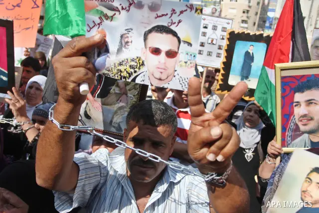 Palestinians attend a demonstration calling for the release of prisoners held in Israeli jails and in support of inmates in hunger strike, on October 3, 2011 in the West Bank city of Ramallah. Thousands of Palestinian in...