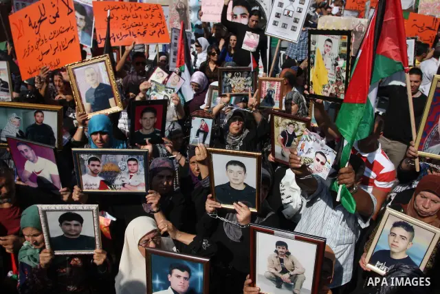 Palestinians attend a demonstration calling for the release of prisoners held in Israeli jails and in support of inmates in hunger strike, on October 3, 2011 in the West Bank city of Ramallah. Thousands of Palestinian in...