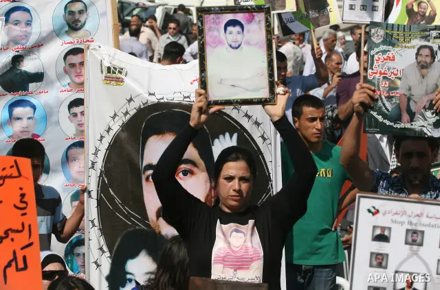 Palestinians attend a demonstration calling for the release of prisoners held in Israeli jails and in support of inmates in hunger strike, on October 3, 2011 in the West Bank city of Ramallah. Thousands of Palestinian in...