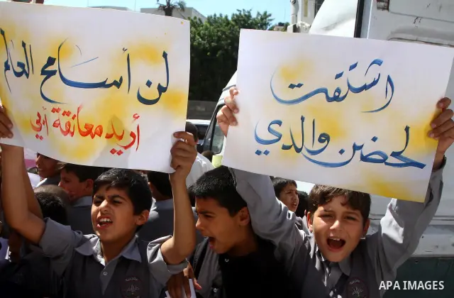 Palestinian students take part in a protest demanding for release of Palestinian prisoners in Israeli jails, at the Red Cross head headquarters in Gaza City on Oct. 4, 2011. Palestinians continue their protests in the We...