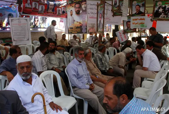 Palestinians take part in a protest demanding for release of Palestinian prisoners in Israeli jails, at the Red Cross head headquarters in Gaza City on Oct. 4, 2011. Palestinians continue their protests in the West Bank...