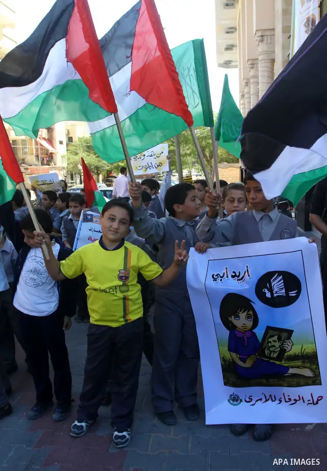 Palestinian students take part in a protest demanding for release of Palestinian prisoners in Israeli jails, at the Red Cross head headquarters in Gaza City on Oct. 4, 2011. Palestinians continue their protests in the We...
