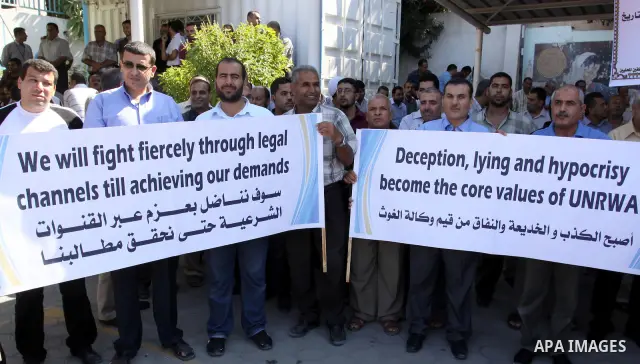Palestinians take part in a protest against the decision to stop the head of the Federation of staff, Suhail al-Hindi to work temporarily, in front of the UNRWA headquarters in Gaza City on Oct. 5,2011. Union officials c...