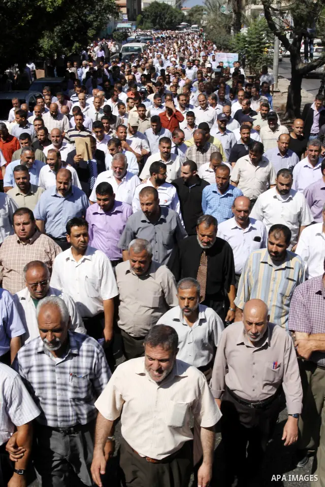 Palestinians take part in a protest against the decision to stop the head of the Federation of staff, Suhail al-Hindi to work temporarily, in front of the UNRWA headquarters in Gaza City on Oct. 5,2011. Union officials c...