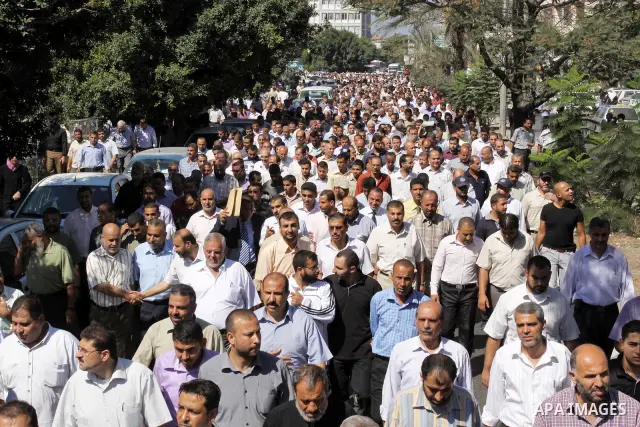 Palestinians take part in a protest against the decision to stop the head of the Federation of staff, Suhail al-Hindi to work temporarily, in front of the UNRWA headquarters in Gaza City on Oct. 5,2011. Union officials c...