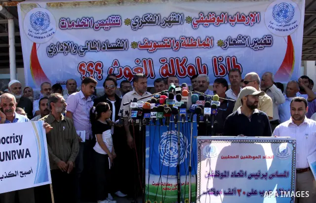Palestinians take part in a protest against the decision to stop the head of the Federation of staff, Suhail al-Hindi to work temporarily, in front of the UNRWA headquarters in Gaza City on Oct. 5,2011. Union officials c...