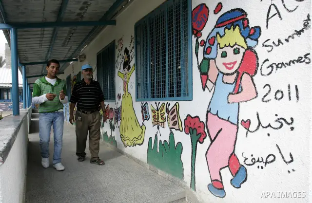 Palestinian men walk in an empty class because of a strike of teachers at a school in Rafah, southern Gaza Strip on October 5, 2011. Union officials called the United Nations Relief and Works Agency (UNRWA) employees to...