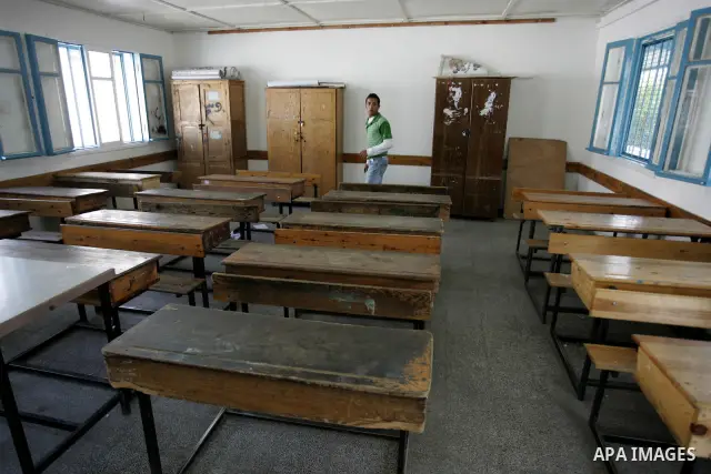 A Palestinian man stands in an empty class because of a strike of teachers at a school in Rafah, southern Gaza Strip on October 5, 2011. Union officials called the United Nations Relief and Works Agency (UNRWA) employees...