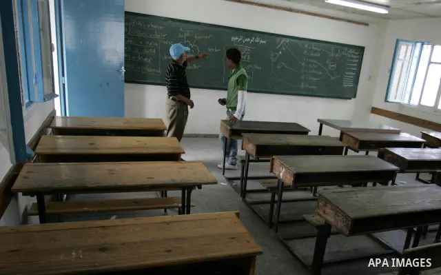 Palestinian men stand in an empty class because of a strike of teachers at a school in Rafah, southern Gaza Strip on October 5, 2011. Union officials called the United Nations Relief and Works Agency (UNRWA) employees to...