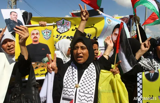 Palestinians take part in a protest near the Erez border crossing between Israel and northern Gaza Strip October 5, 2011, to show their solidarity with Palestinian prisoners held in Israeli jails. Hundreds of Palestinian...