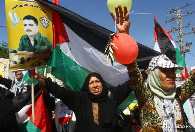 Palestinians take part in a protest near the Erez border crossing between Israel and northern Gaza Strip October 5, 2011, to show their solidarity with Palestinian prisoners held in Israeli jails. Hundreds of Palestinian...