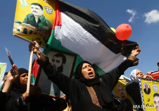 Palestinians take part in a protest near the Erez border crossing between Israel and northern Gaza Strip October 5, 2011, to show their solidarity with Palestinian prisoners held in Israeli jails. Hundreds of Palestinian...