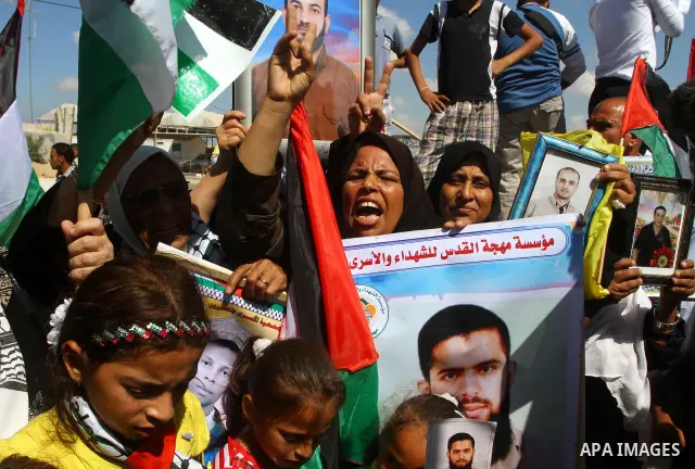 Palestinians take part in a protest near the Erez border crossing between Israel and northern Gaza Strip October 5, 2011, to show their solidarity with Palestinian prisoners held in Israeli jails. Hundreds of Palestinian...