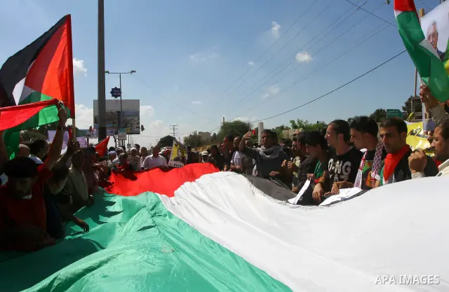 Palestinians take part in a protest near the Erez border crossing between Israel and northern Gaza Strip October 5, 2011, to show their solidarity with Palestinian prisoners held in Israeli jails. Hundreds of Palestinian...