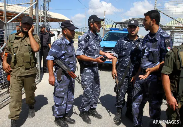 Hamas security forces stand guard as Palestinians take part in a protest near the Erez border crossing between Israel and northern Gaza Strip October 5, 2011, to show their solidarity with Palestinian prisoners held in I...
