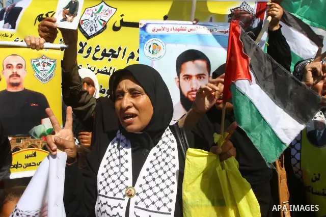 Palestinians take part in a protest near the Erez border crossing between Israel and northern Gaza Strip October 5, 2011, to show their solidarity with Palestinian prisoners held in Israeli jails. Hundreds of Palestinian...