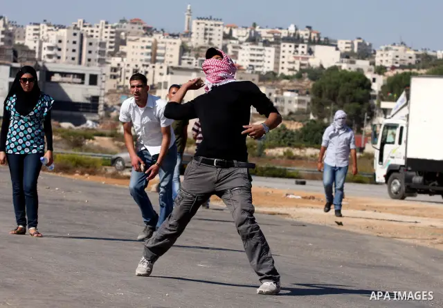 Palestinian protestors clash with Israeli forces during a demonstration calling for the release of prisoners held in Israeli jails and in support of inmates in hunger strike, on October 5, 2011 near Israel's Ofer prison,...