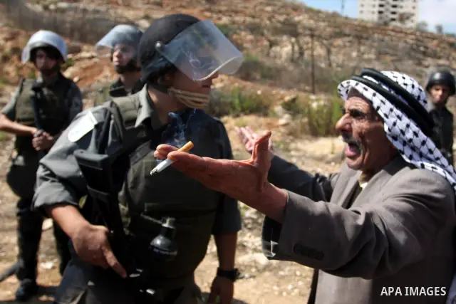 An elderly Palestinian man shout slogans near Israeli policemen during a demonstration calling for the release of prisoners held in Israeli jails and in support of inmates in hunger strike, on October 5, 2011 near Israel...
