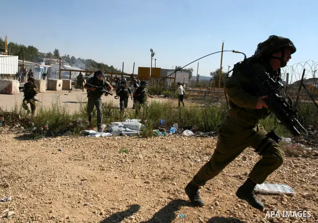 Israeli forces clash with Palestinian protestors during a demonstration calling for the release of prisoners held in Israeli jails and in support of inmates in hunger strike, on October 5, 2011 near Israel's Ofer prison,...