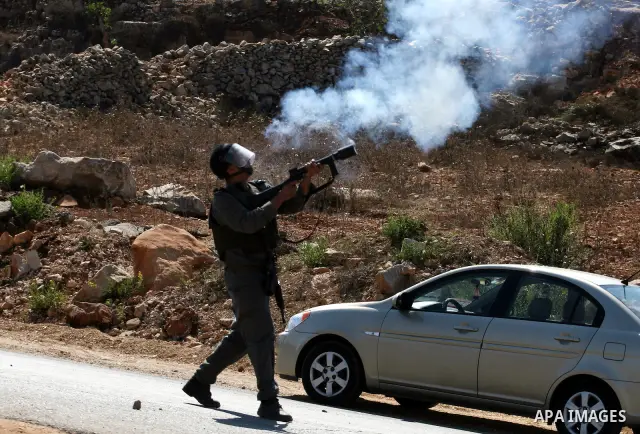 Israeli forces clash with Palestinian protestors during a demonstration calling for the release of prisoners held in Israeli jails and in support of inmates in hunger strike, on October 5, 2011 near Israel's Ofer prison,...