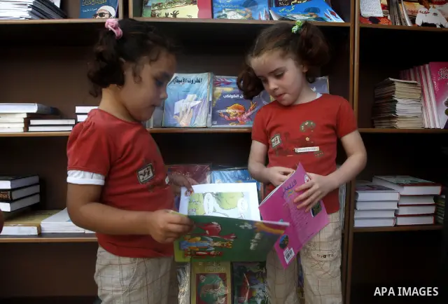 Palestinian children look at kids stories during the opening ceremony of the book exhibition which organised by the Ministry of Culture in Gaza city on Oct. 5,2011. Palestinian Prime Minister in Gaza Strip, Ismail Haniya...
