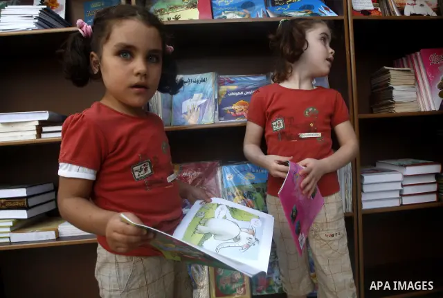 Palestinian children look at kids stories during the opening ceremony of the book exhibition which organised by the Ministry of Culture in Gaza city on Oct. 5,2011. Palestinian Prime Minister in Gaza Strip, Ismail Haniya...