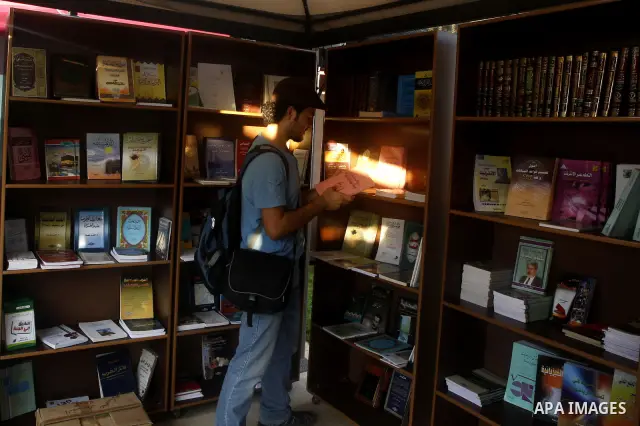A Palestinian youth searches for books during the opening ceremony of the book exhibition which organised by the Ministry of Culture in Gaza city on Oct. 5,2011. Palestinian Prime Minister in Gaza Strip, Ismail Haniya at...