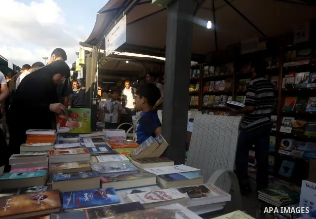 Palestinians search for books during the opening ceremony of the book exhibition which organised by the Ministry of Culture in Gaza city on Oct. 5,2011. Palestinian Prime Minister in Gaza Strip, Ismail Haniya attended th...