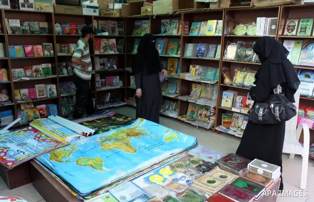 Palestinians search for books during the opening ceremony of the book exhibition which organised by the Ministry of Culture in Gaza city on Oct. 5,2011. Palestinian Prime Minister in Gaza Strip, Ismail Haniya attended th...