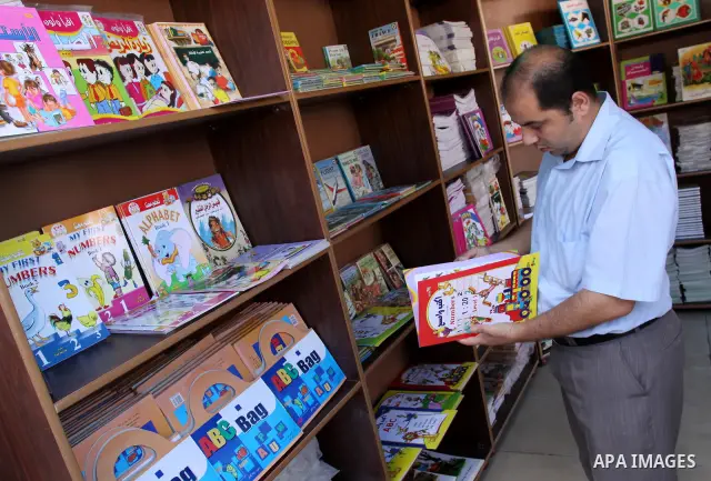 Palestinians search for books during the opening ceremony of the book exhibition which organised by the Ministry of Culture in Gaza city on Oct. 5,2011. Palestinian Prime Minister in Gaza Strip, Ismail Haniya attended th...