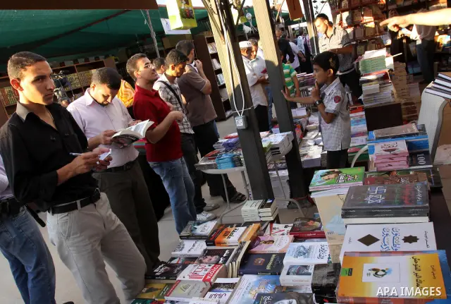 Palestinians search for books during the opening ceremony of the book exhibition which organised by the Ministry of Culture in Gaza city on Oct. 5,2011. Palestinian Prime Minister in Gaza Strip, Ismail Haniya attended th...
