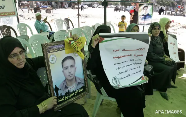 Palestinians take part in a protest in a solidarity tent with prisoners jailed in Israeli in Rafah, southern Gaza Strip on Oct, 6, 2011, to show their solidarity with Palestinian prisoners held in Israeli jails. Hundreds...