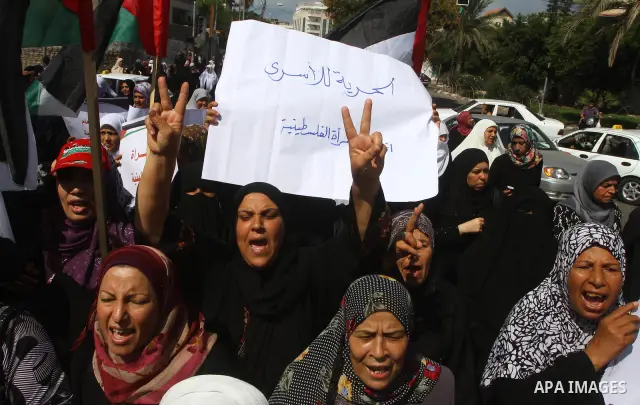 Palestinian women take part in a protest in Gaza City Oct, 06, 2011, to show solidarity with Palestinian prisoners held in Israeli jails. Hundreds of Palestinians in Israeli jails have joined a hunger strike to protest a...