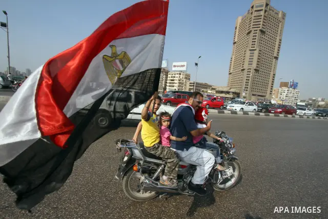 Egyptian boy holds his national flag as military aircrafts fly during an air show in Cairo, Egypt Thursday, Oct. 6, 2011. Egypt marked the 38th anniversary of the Oct. 6 Arab-Israeli war in 1973 on Thursday. In 1973 Egyp...
