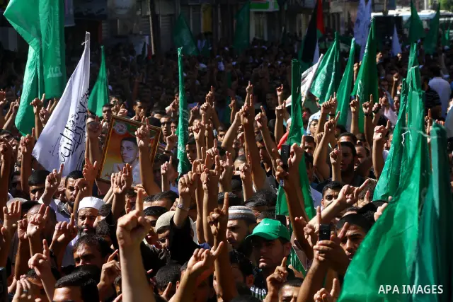 Palestinian Hamas supporters take part in a rally in Jabalya, northern Gaza Strip October 7, 2011, to show solidarity with Palestinian prisoners held in Israeli jails. Hundreds of Palestinians in Israeli jails have joine...