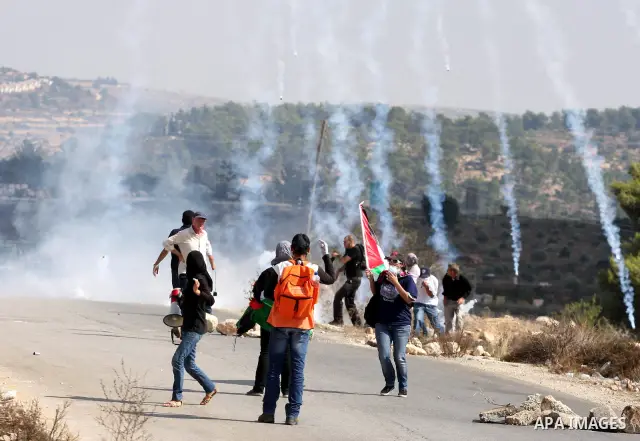 Israeli soldiers fire tear gas canister to disperse Palestinian stone throwers during clashes following a weekly demonstration against Israeli settlement expansion, in the West Bank village of Nabi Saleh, on October 7, 2...